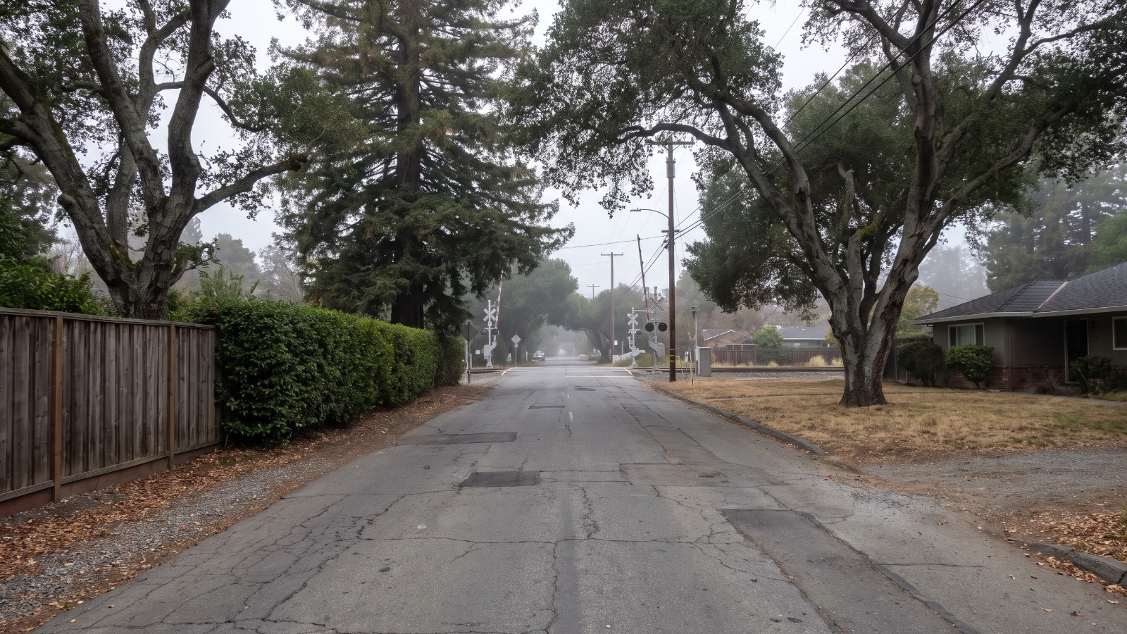 A quiet Atherton residential street running down to the Caltrain crossing near Menlo Park, the corridor that makes the proposed Atherton townhomes legal under SB 79.