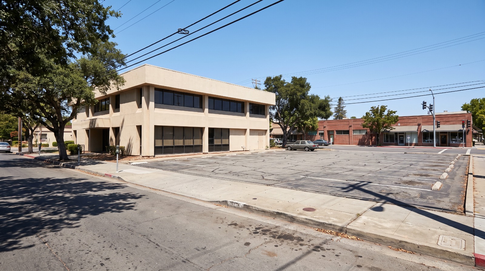 The vacant bank building and surface parking lot at Oak Grove Avenue and Crane Street in downtown Menlo Park, site of 15 approved condominiums.