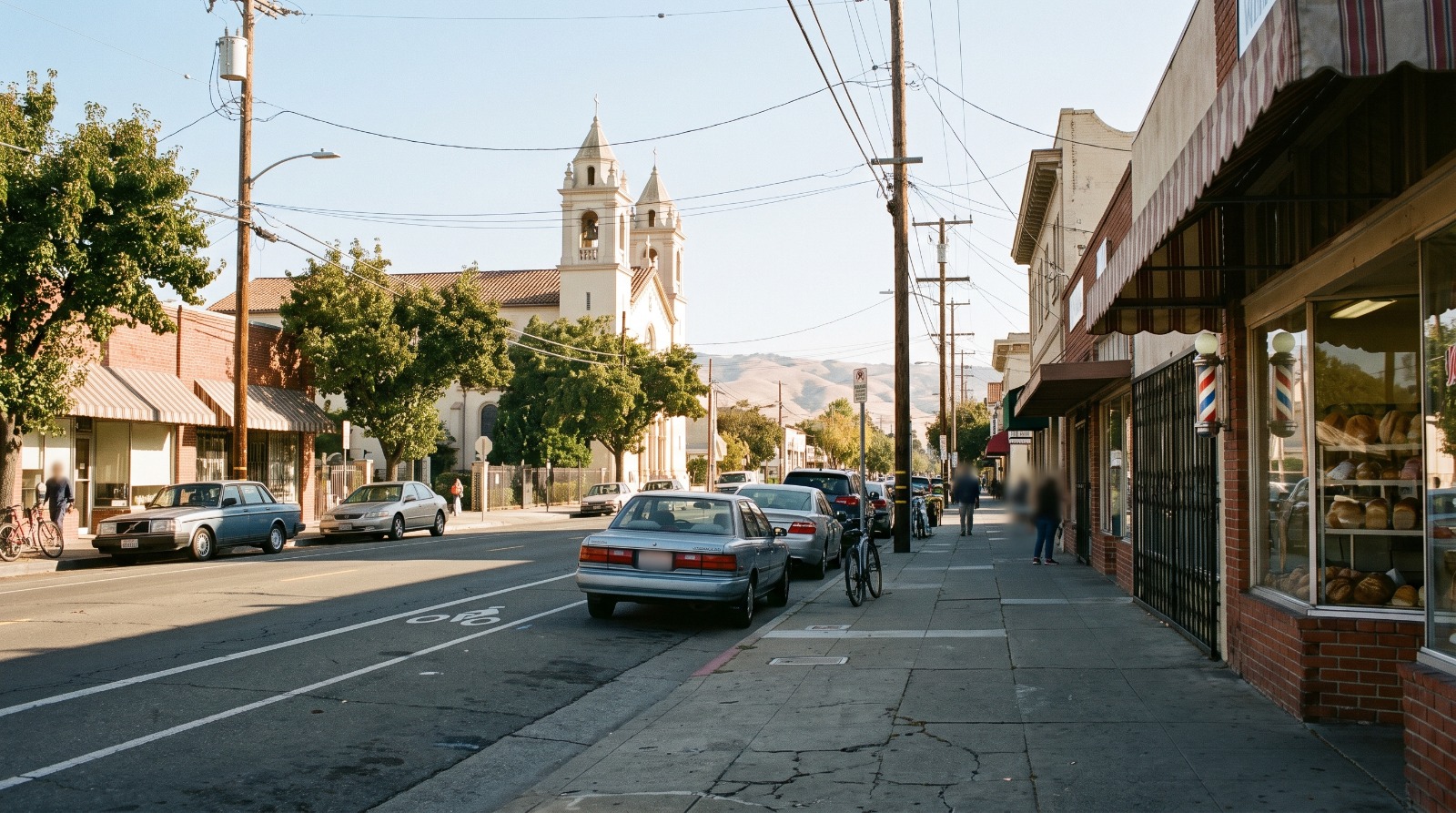 East Santa Clara Street in Little Portugal, San Jose, with the Five Wounds church towers rising behind the storefronts inside the Five Wounds Urban Village plan area.
