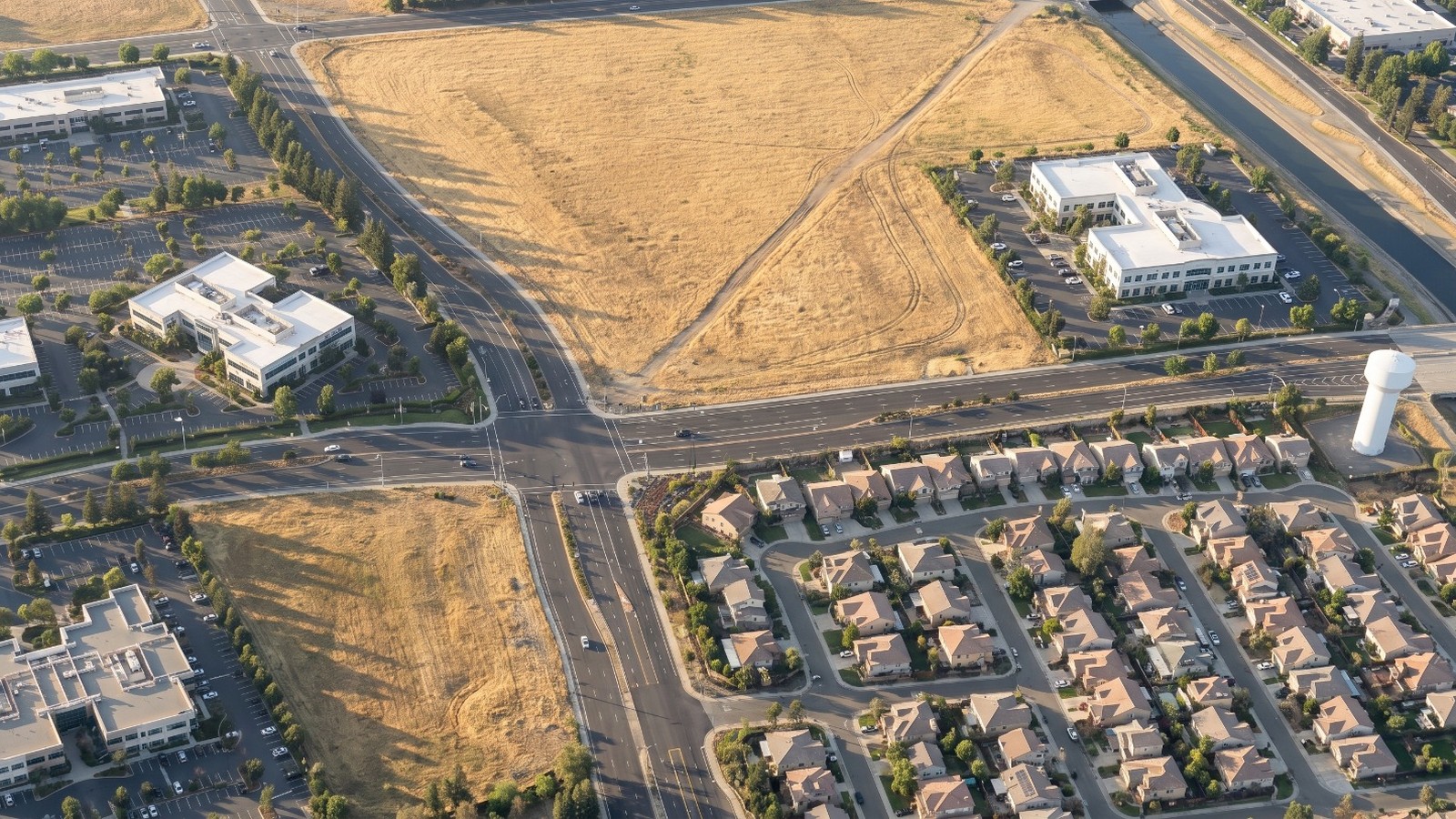 AI-rendered oblique aerial view of the empty fields at International Drive and Kilgore Road in Rancho Cordova, planned for 166 houses