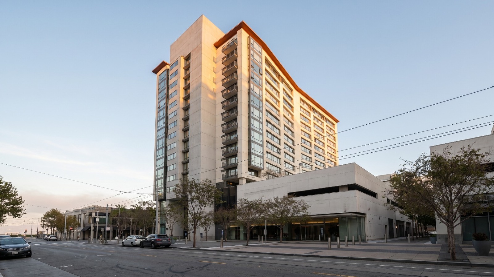 AI-rendered golden-hour view of The Beacon condominium tower at 250 King Street in San Francisco, home to one of the city's BMR condos for sale