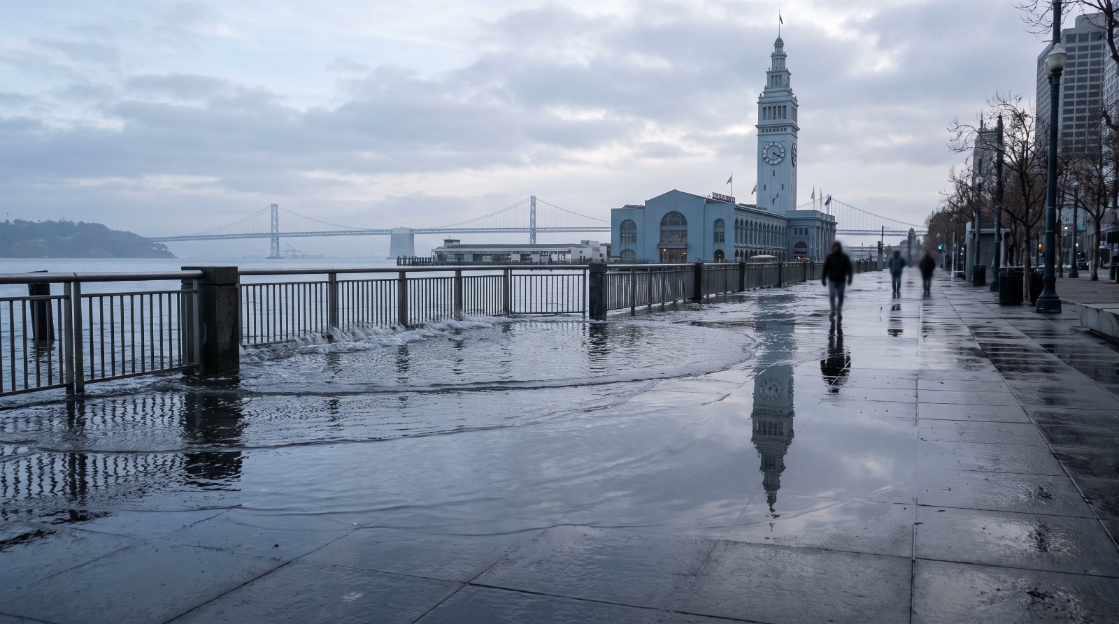 King tide water pooling across the Embarcadero promenade near the Ferry Building in San Francisco