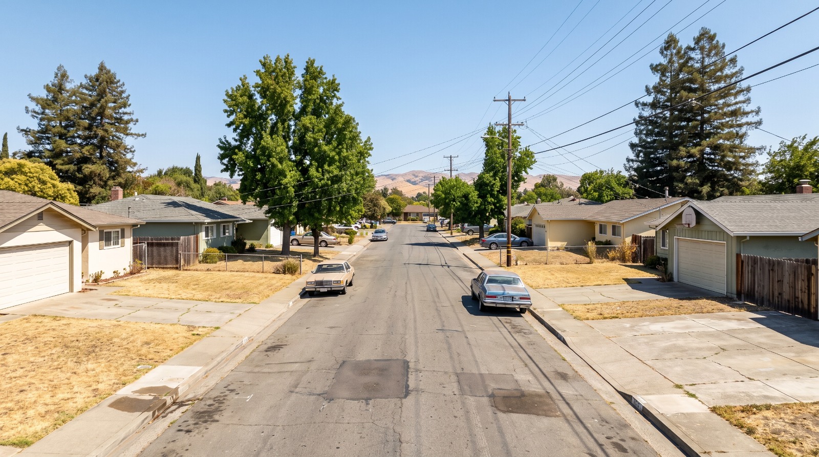 A flat street of single-story 1950s homes on wide lots in an inner Bay Area suburb, the kind of parcel California’s SB 1116 lot split rules would apply to.