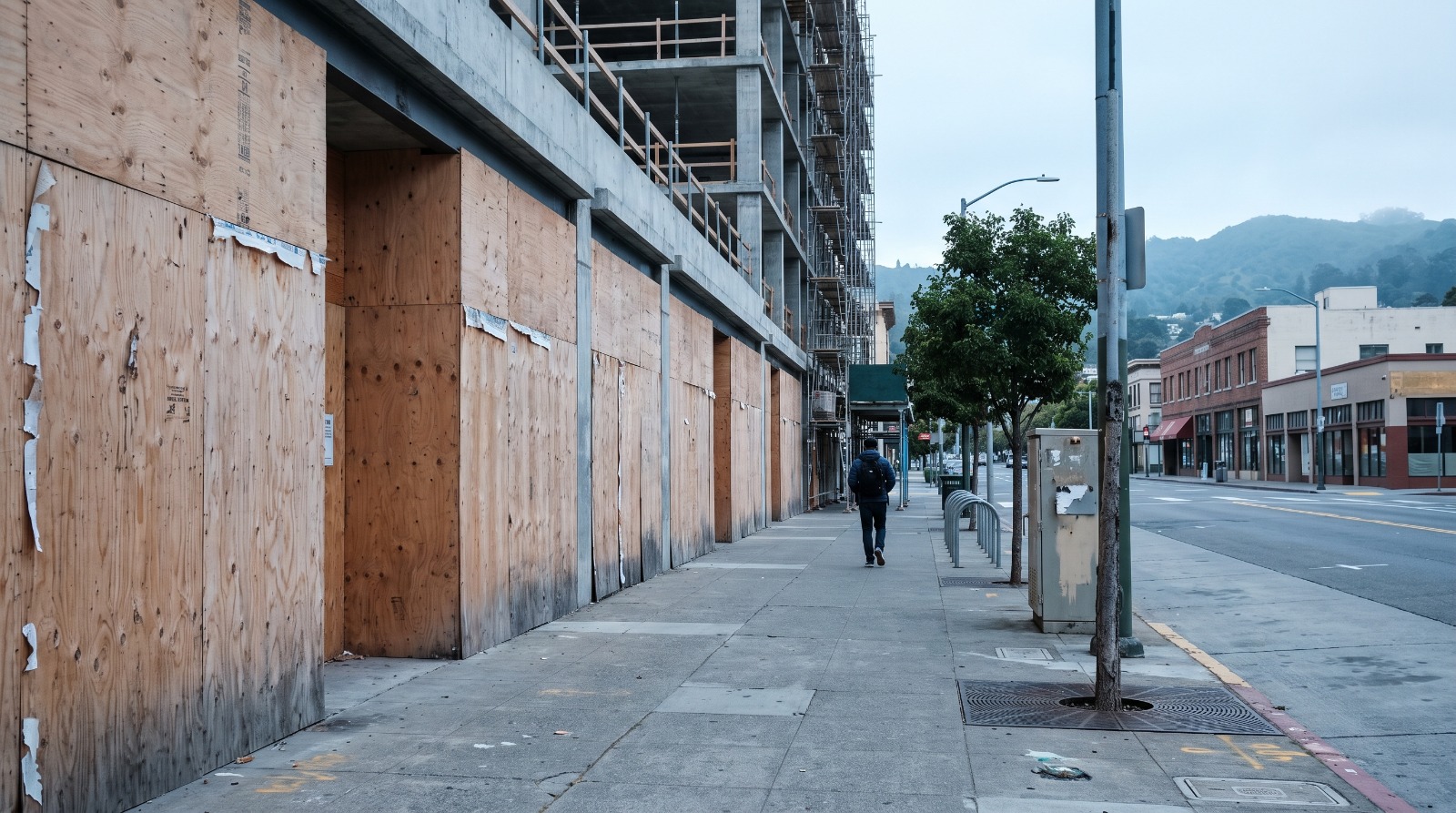 Boarded-up ground-floor storefronts on Center Street in Downtown Berkeley, one of the stalled construction sites the city's new blight standards would cover.