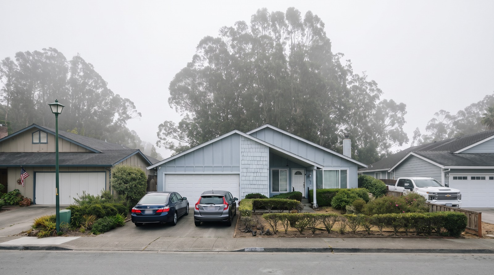 AI-rendered view of Coral Reef Avenue in El Granada under morning fog, one-story homes with the eucalyptus grove of the proposed rezoning site behind them