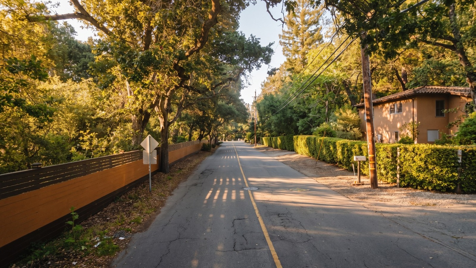 AI-rendered golden-hour view of Walsh Road in Atherton, an oak-covered lane with hedges and no sidewalks, near the former Jerry Rice estate listed for $35 million