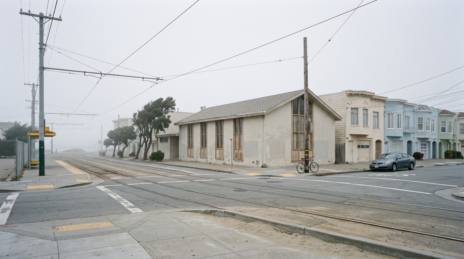 The low mid-century former church building at Judah Street and 46th Avenue in San Francisco's Outer Sunset, with N Judah tracks running past.