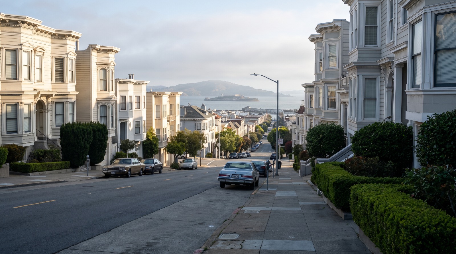 Morning view down a steep Pacific Heights street toward San Francisco Bay, the kind of block where Bay Area luxury home sales rose 39 percent in the first half of 2026.