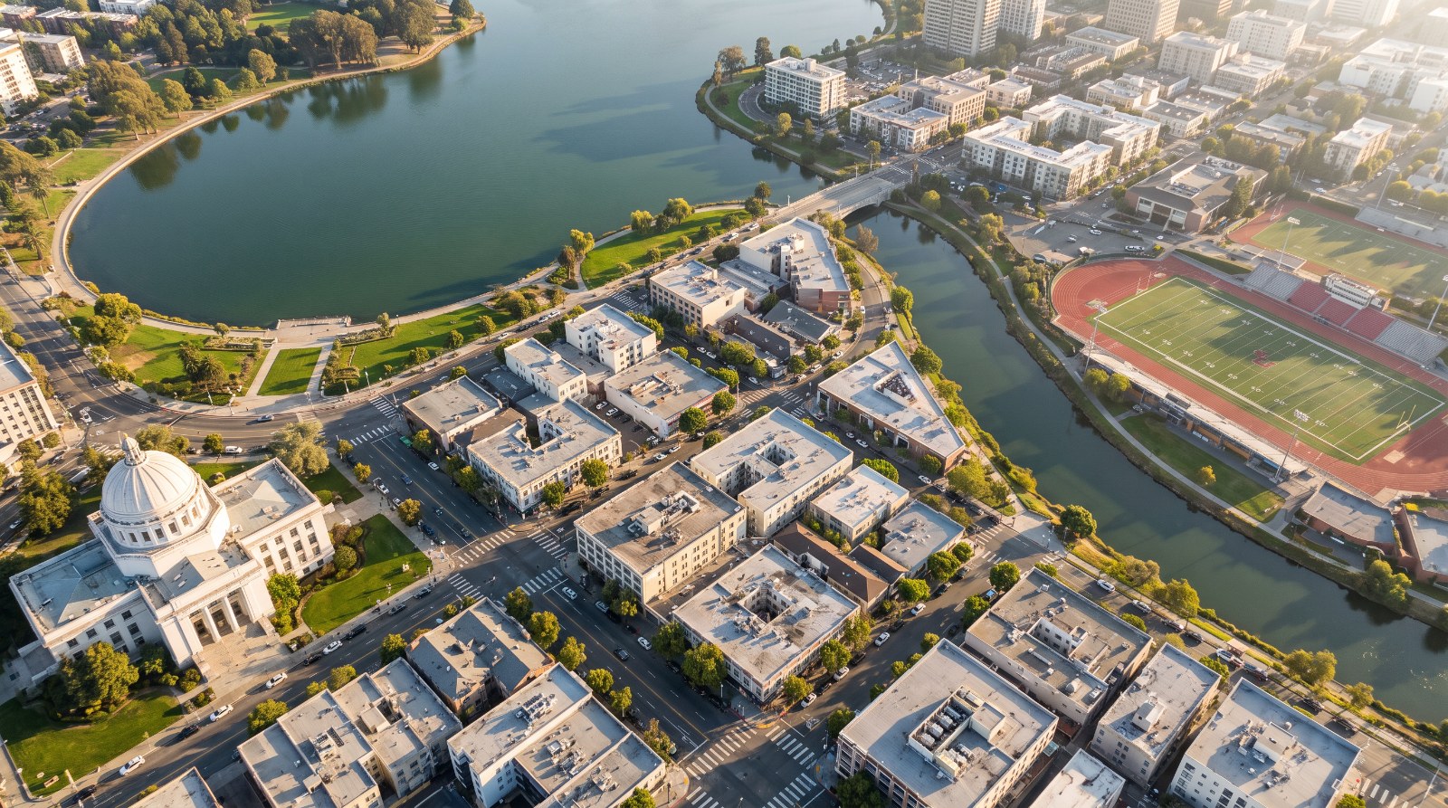 AI-rendered oblique aerial view of the south end of Lake Merritt in Oakland, with the 12th Street shoreline, the Lake Merritt Channel, Laney College and the Alameda County Courthouse