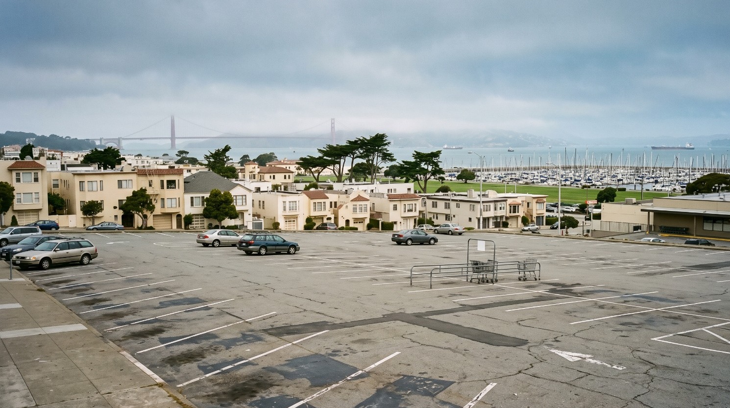 The Safeway parking lot at 15 Marina Boulevard in San Francisco, the site of the Marina Safeway project's proposed 848 apartments, with Marina Green and the bay beyond.