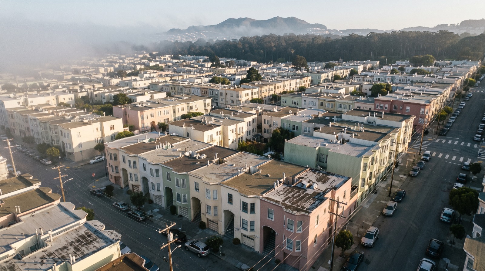 Aerial view of dense pastel row houses in San Francisco's Outer Sunset, the housing stock at the center of the city's affordability debate.