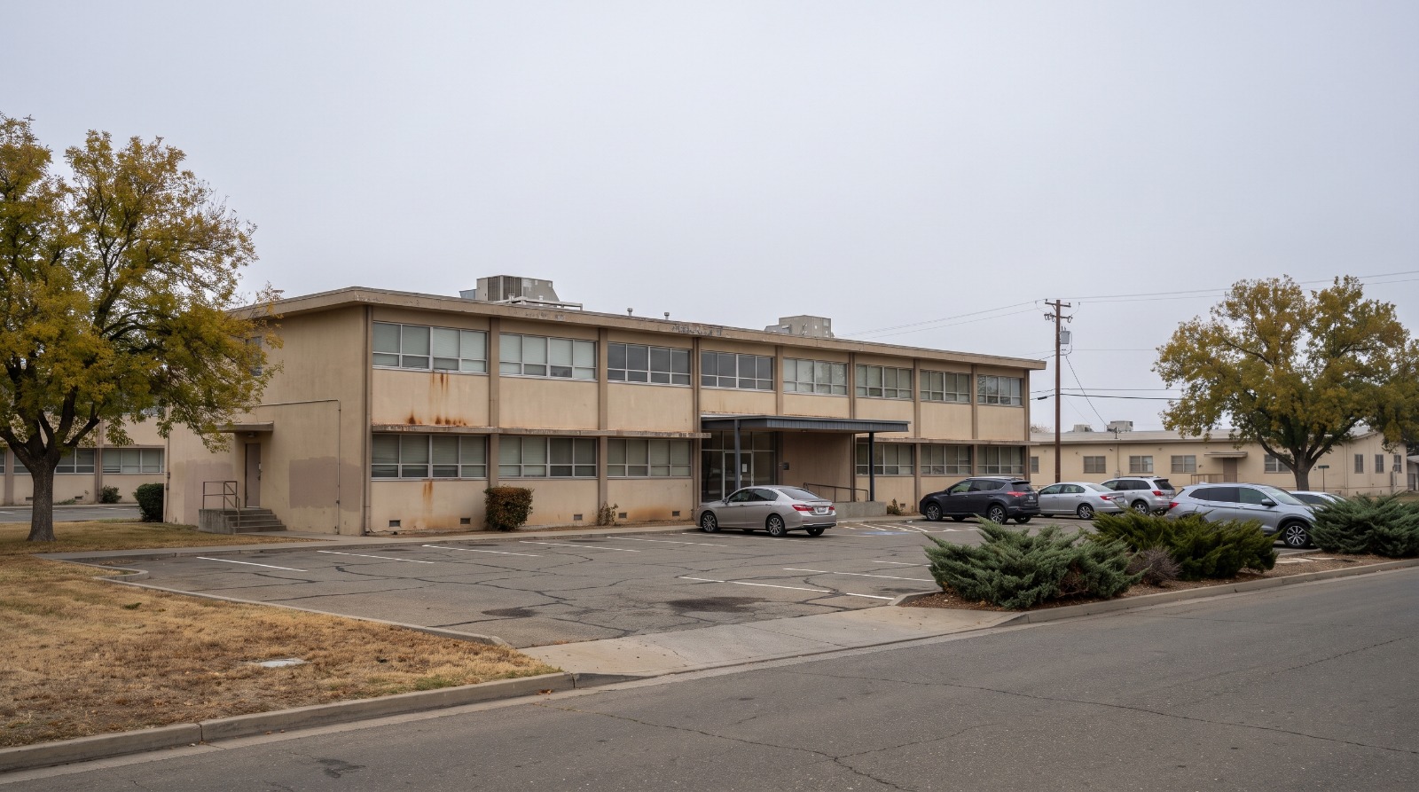 AI-rendered two-story base-era office building and parking lot at McClellan Park in Sacramento County