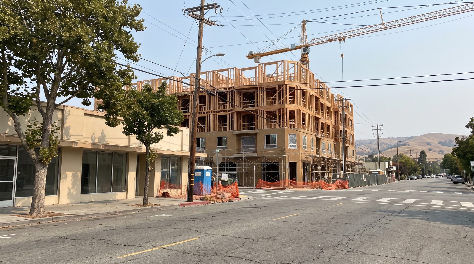 A five-story apartment building under construction on a Peninsula street, the kind of San Mateo County affordable housing project the county's Measure K fund pays into.