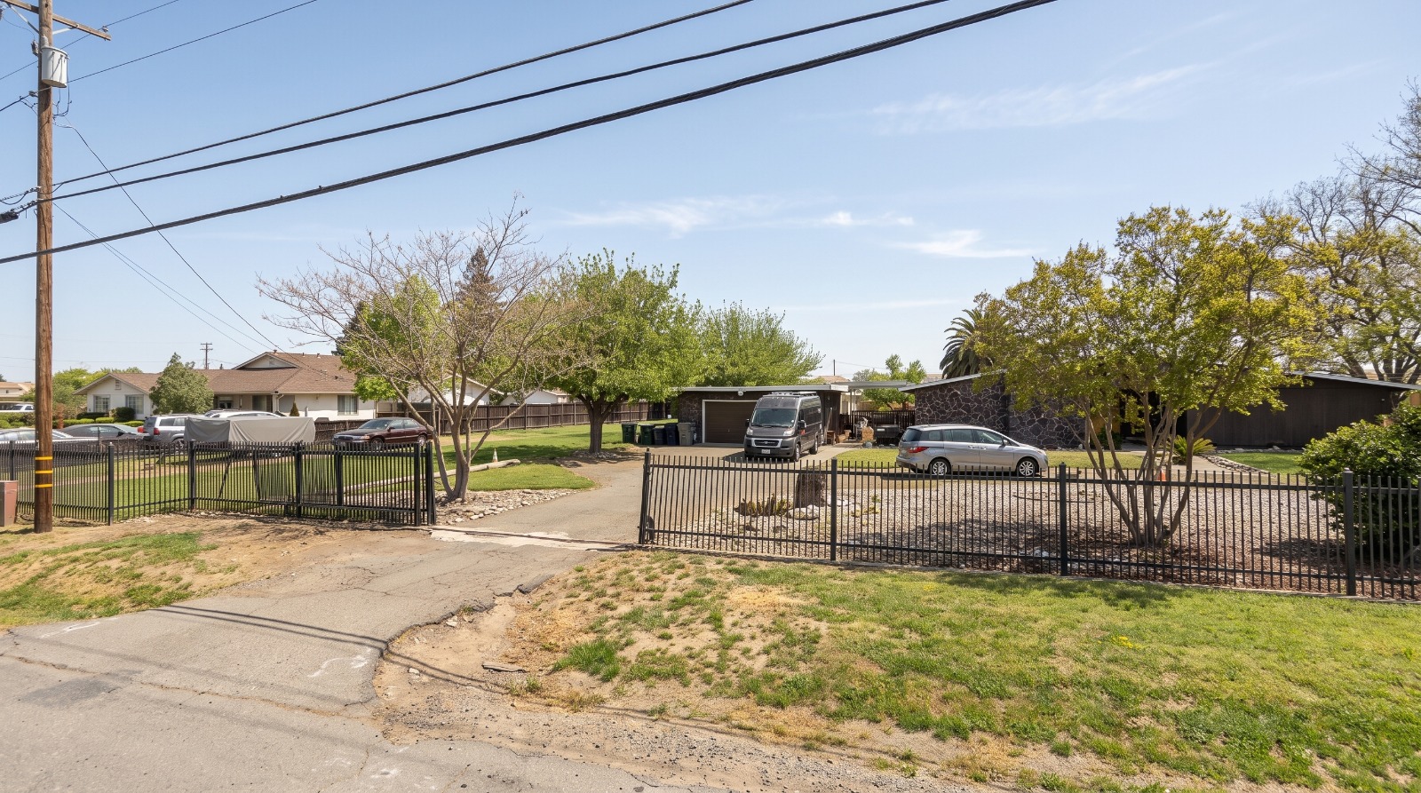 AI-rendered view of 7615 Jacinto Road in south Sacramento as it looks today, a 1967 ranch house behind an iron fence where 29 homes are proposed