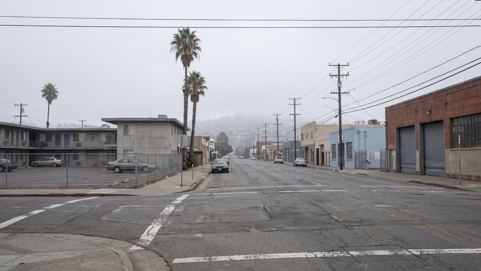 Lower University Avenue in West Berkeley on a foggy morning, the low-rise motel and warehouse corridor around the bankrupt University Inn.