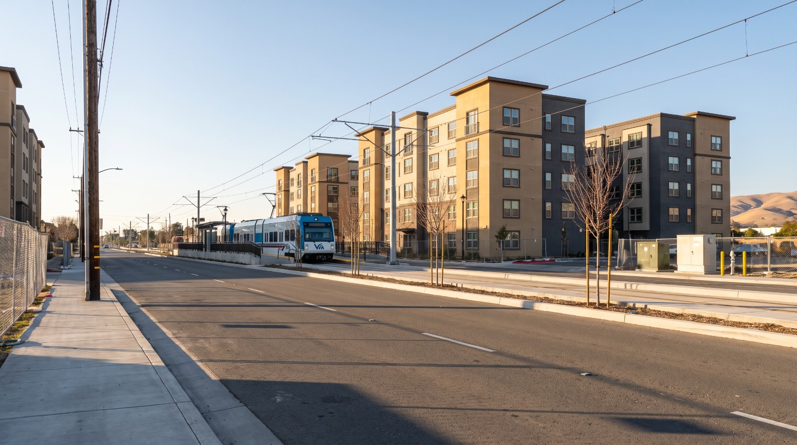 New mid-rise apartment buildings beside a VTA light rail platform on Tasman Drive in Santa Clara, where the Tasman East plan would grow to 6,000 homes.