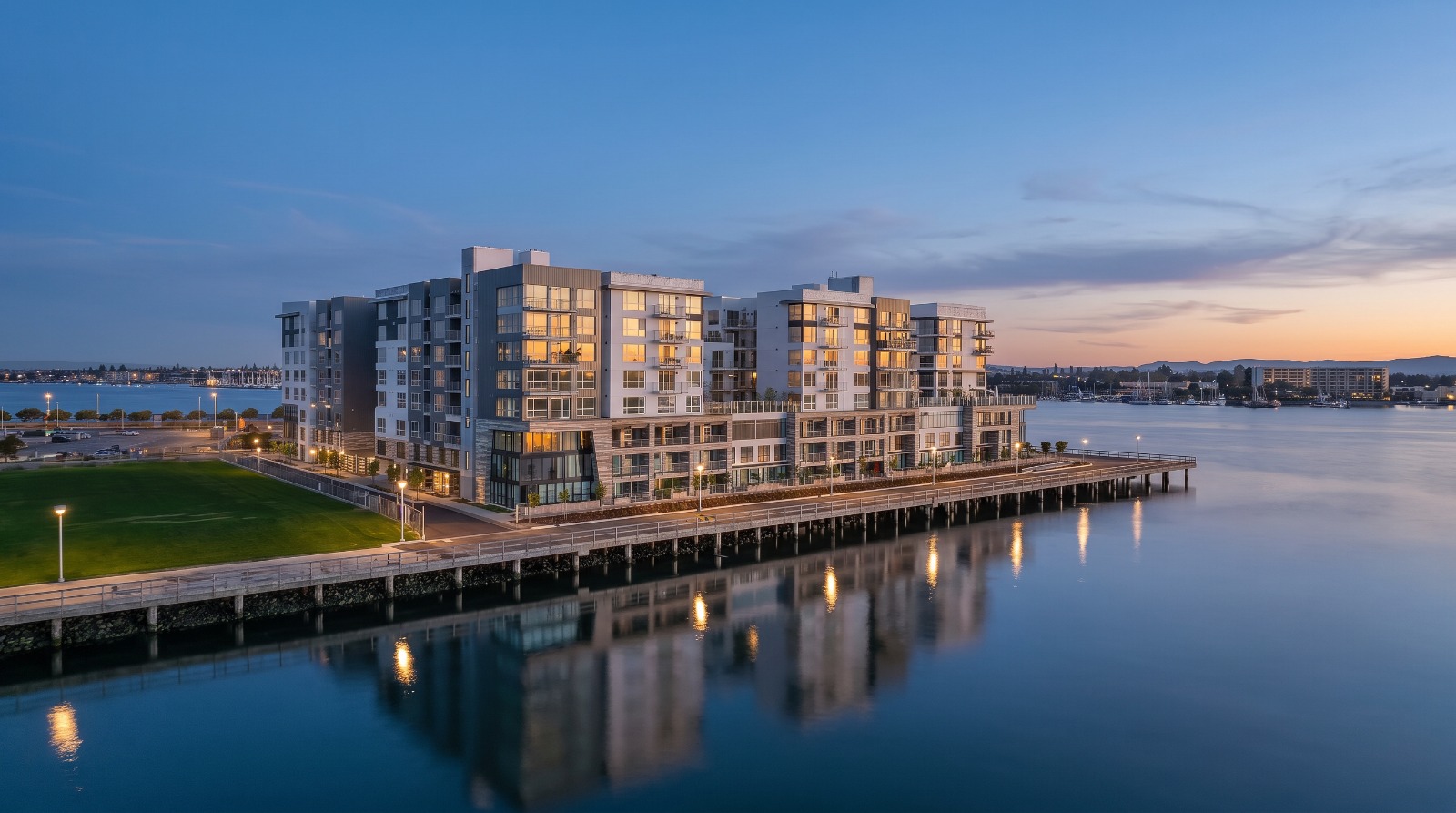 AI-rendered view of the Portico Waterfront apartment building at Brooklyn Basin on the Oakland Estuary at blue hour