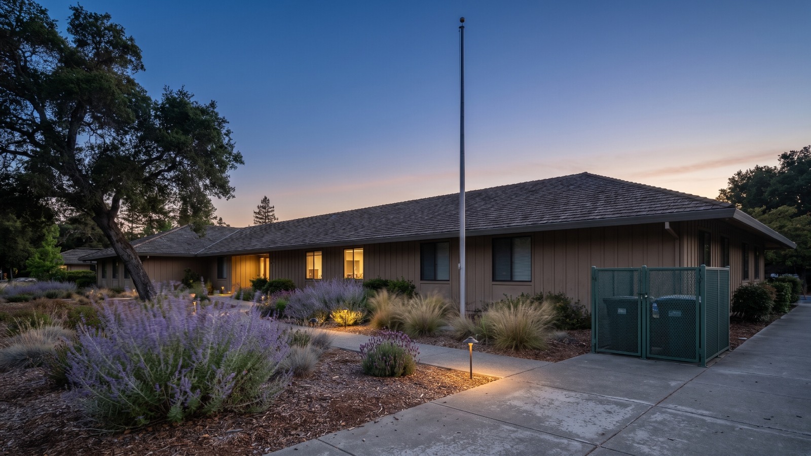 AI-rendered view of the former Sunset Magazine campus at 80 Willow Road in Menlo Park at blue hour, the site of the proposed Willow Park towers
